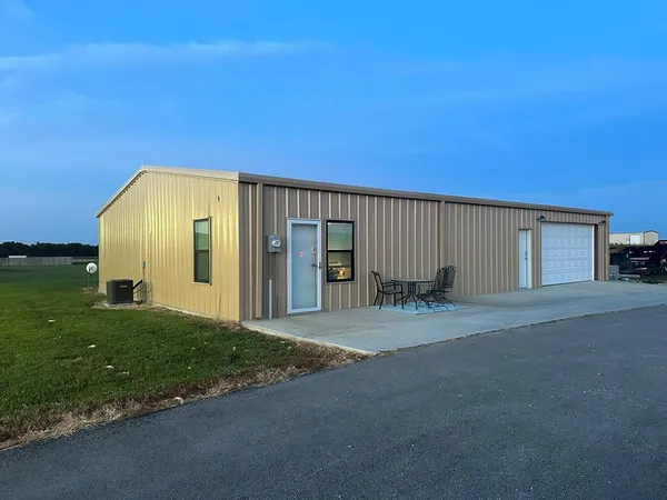 a view of a house with backyard and garage