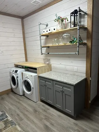 a utility room with sink and cabinets