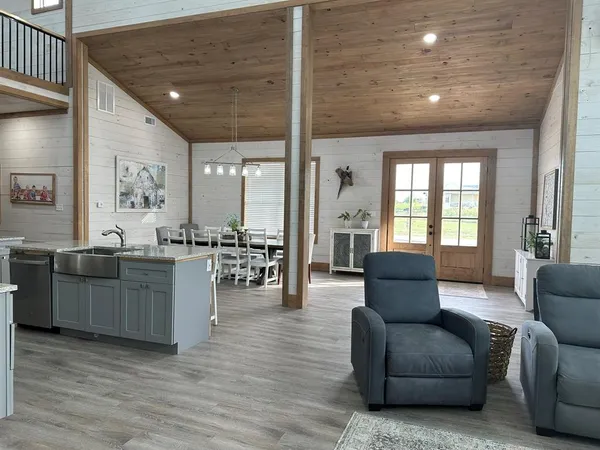 a living room with furniture and wooden floor