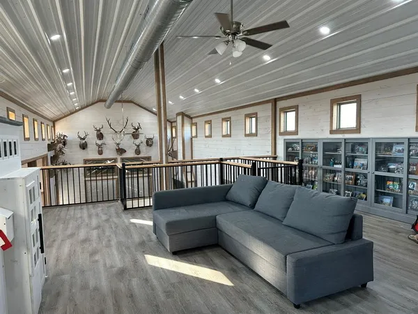 a living room with furniture and a wooden floor