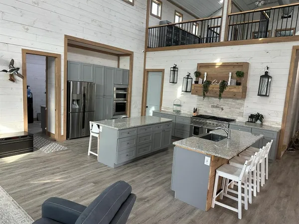 a kitchen with stainless steel appliances granite countertop a sink dishwasher stove and refrigerator