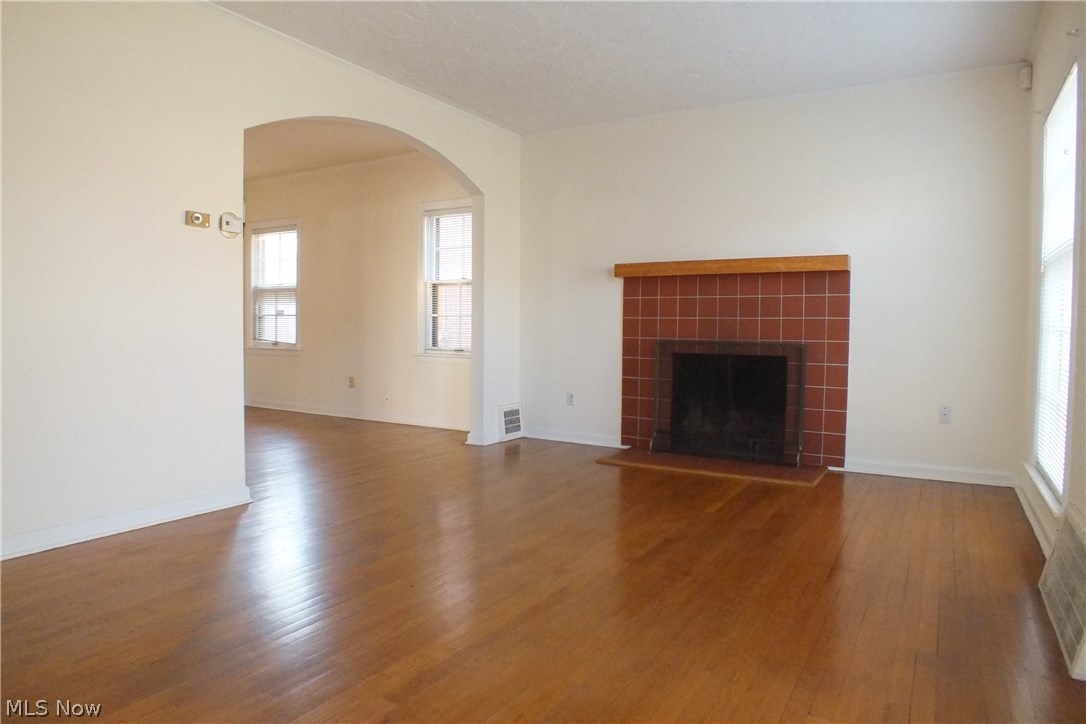 3844 Bethany Road Cleveland, OH 44118 - Photo 6 of 35 The living room with fireplace and archway to the dining room