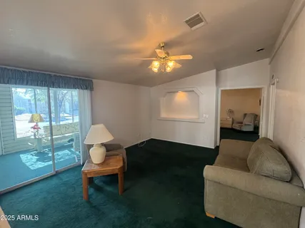 a living room with furniture a lamp and a potted plant
