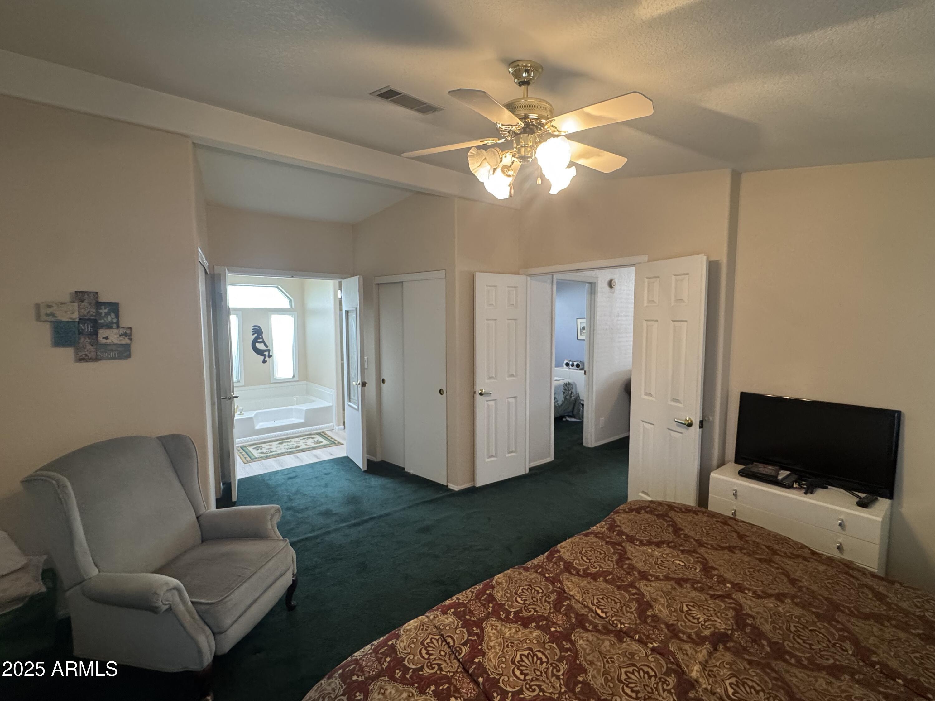 215 North Power Road, Unit 199 Mesa, AZ 85205 - Photo 13 of 27 a living room with furniture and a flat screen tv