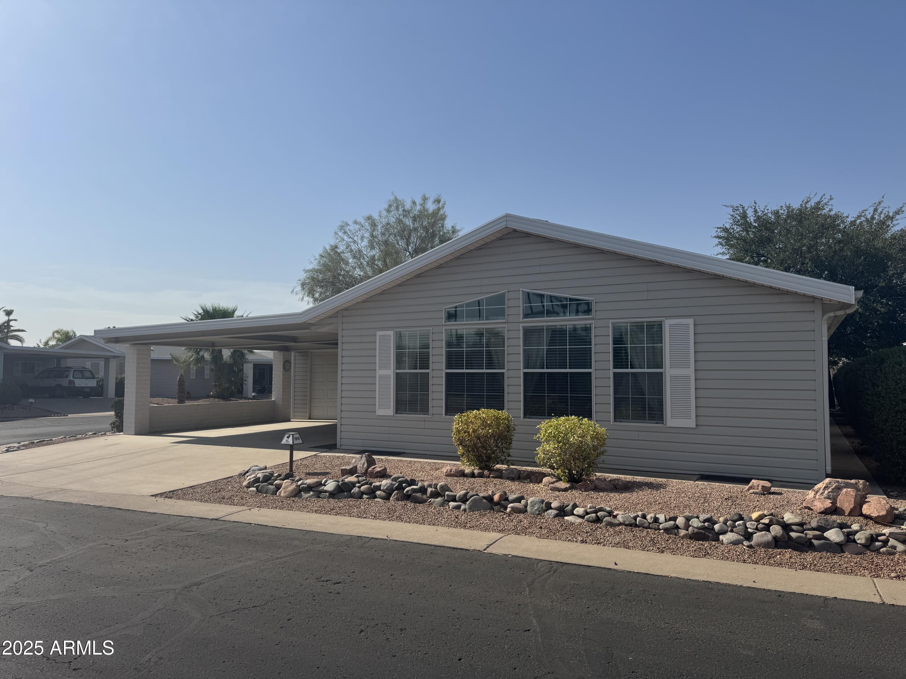 215 North Power Road, Unit 199 Mesa, AZ 85205 - Photo 2 of 27 a front view of a house with a yard