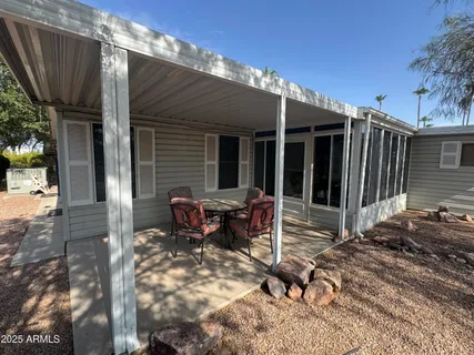 a backyard of a house with yard and outdoor seating