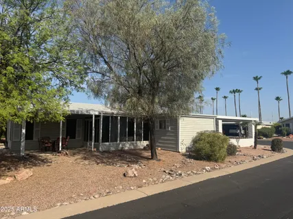 a view of a house with backyard and trees