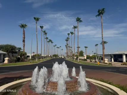 a view of a lake with a bench and trees