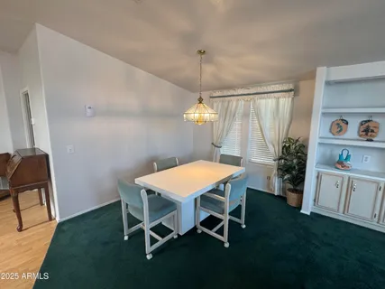 a dining room with furniture and a chandelier