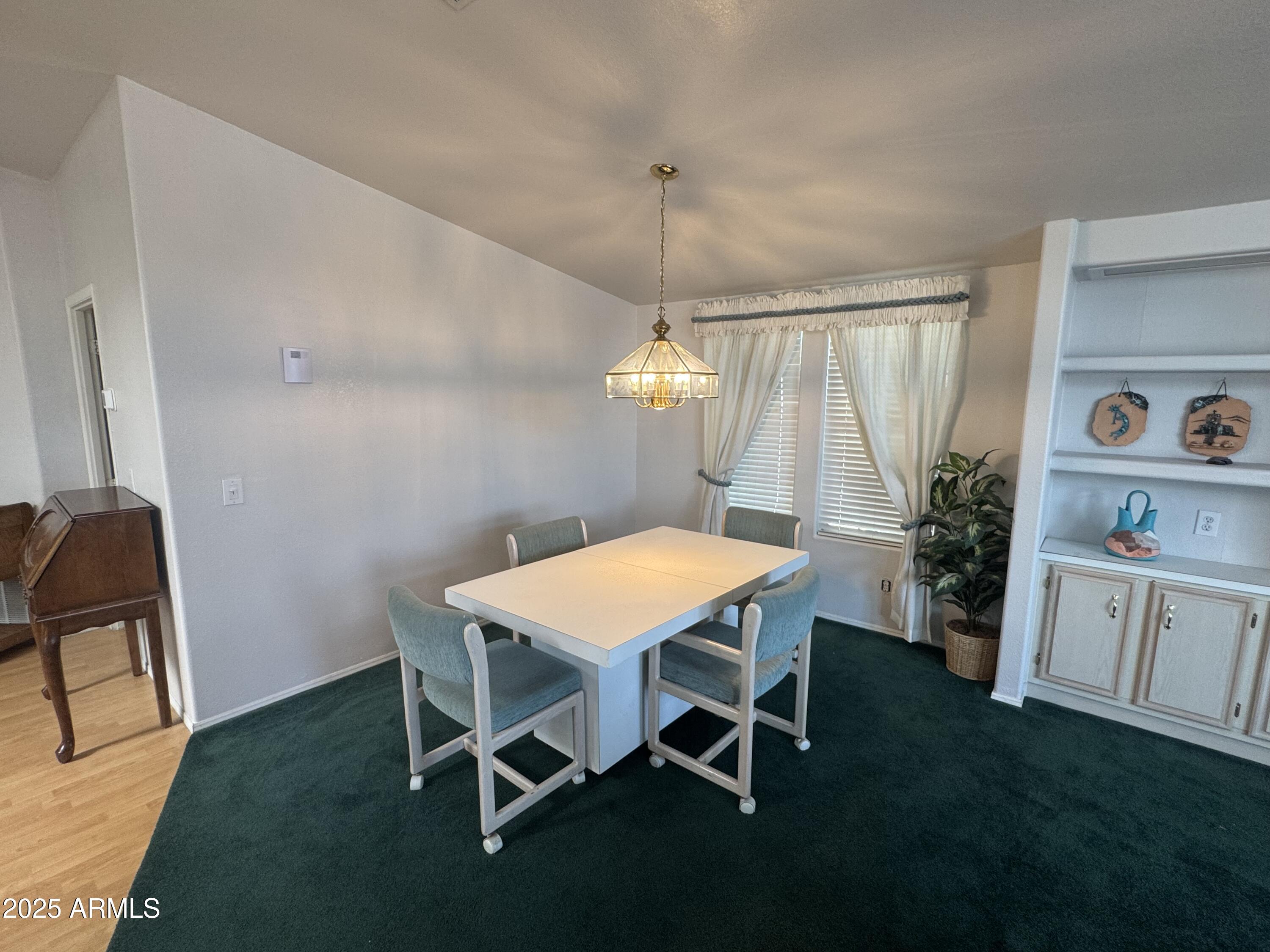 215 North Power Road, Unit 199 Mesa, AZ 85205 - Photo 6 of 27 a dining room with furniture and a chandelier