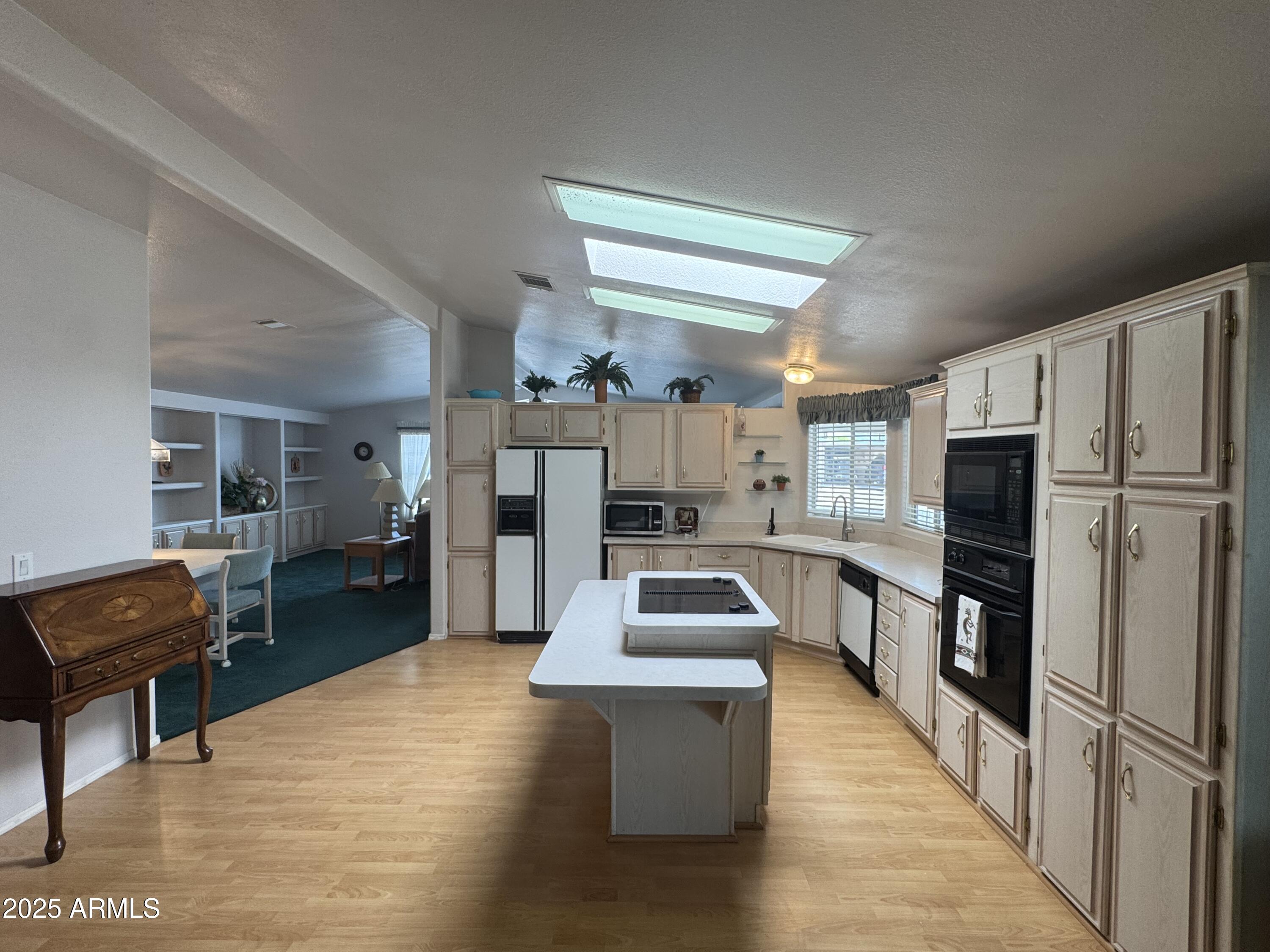 215 North Power Road, Unit 199 Mesa, AZ 85205 - Photo 7 of 27 a kitchen with stainless steel appliances kitchen island granite countertop a refrigerator stove and oven