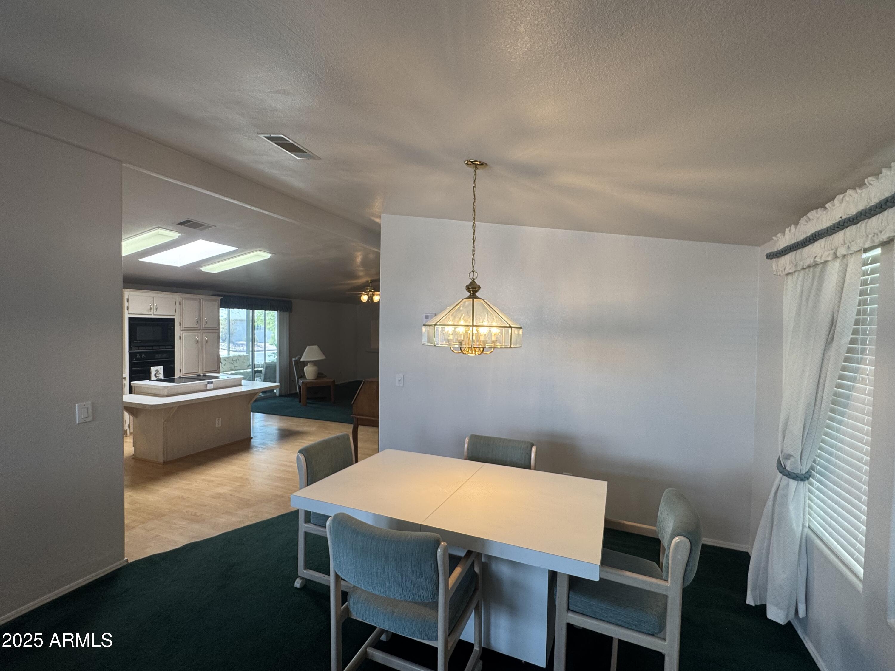215 North Power Road, Unit 199 Mesa, AZ 85205 - Photo 8 of 27 a kitchen with a table and chairs in it