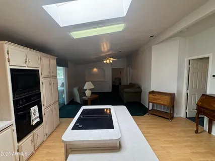 a kitchen with a refrigerator and a stove top oven