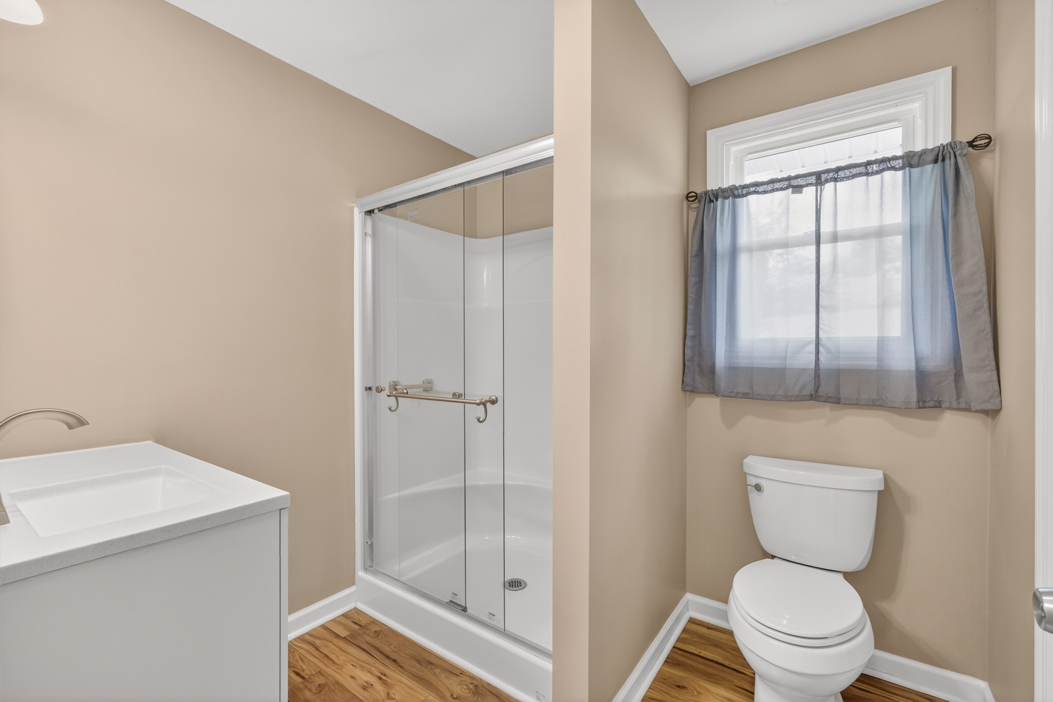 11914 Hogwood Road Milton, TN 37118 - Photo 25 of 44 a bathroom with a toilet a sink and a window