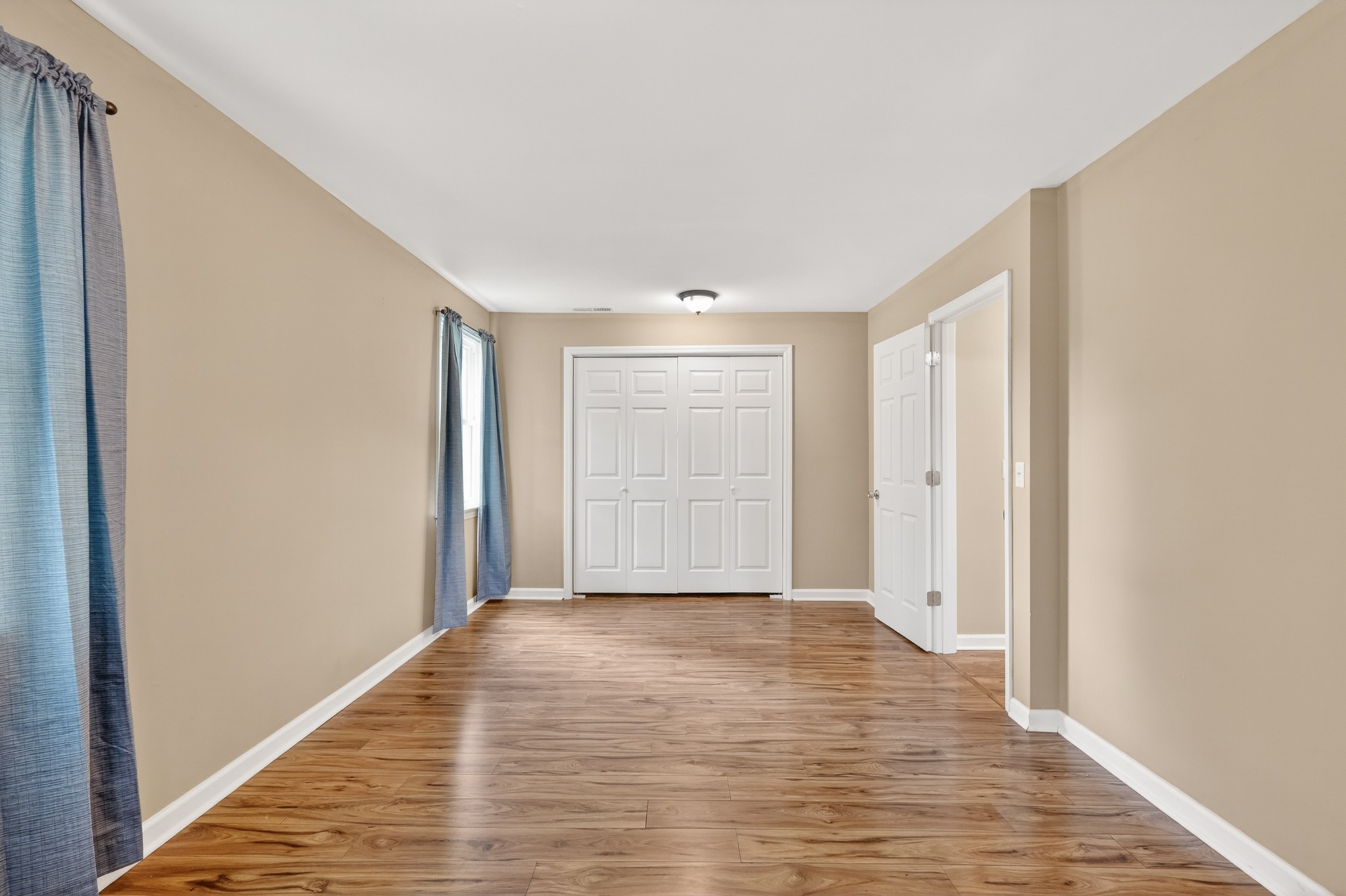 11914 Hogwood Road Milton, TN 37118 - Photo 30 of 44 a view of an empty room with wooden floor