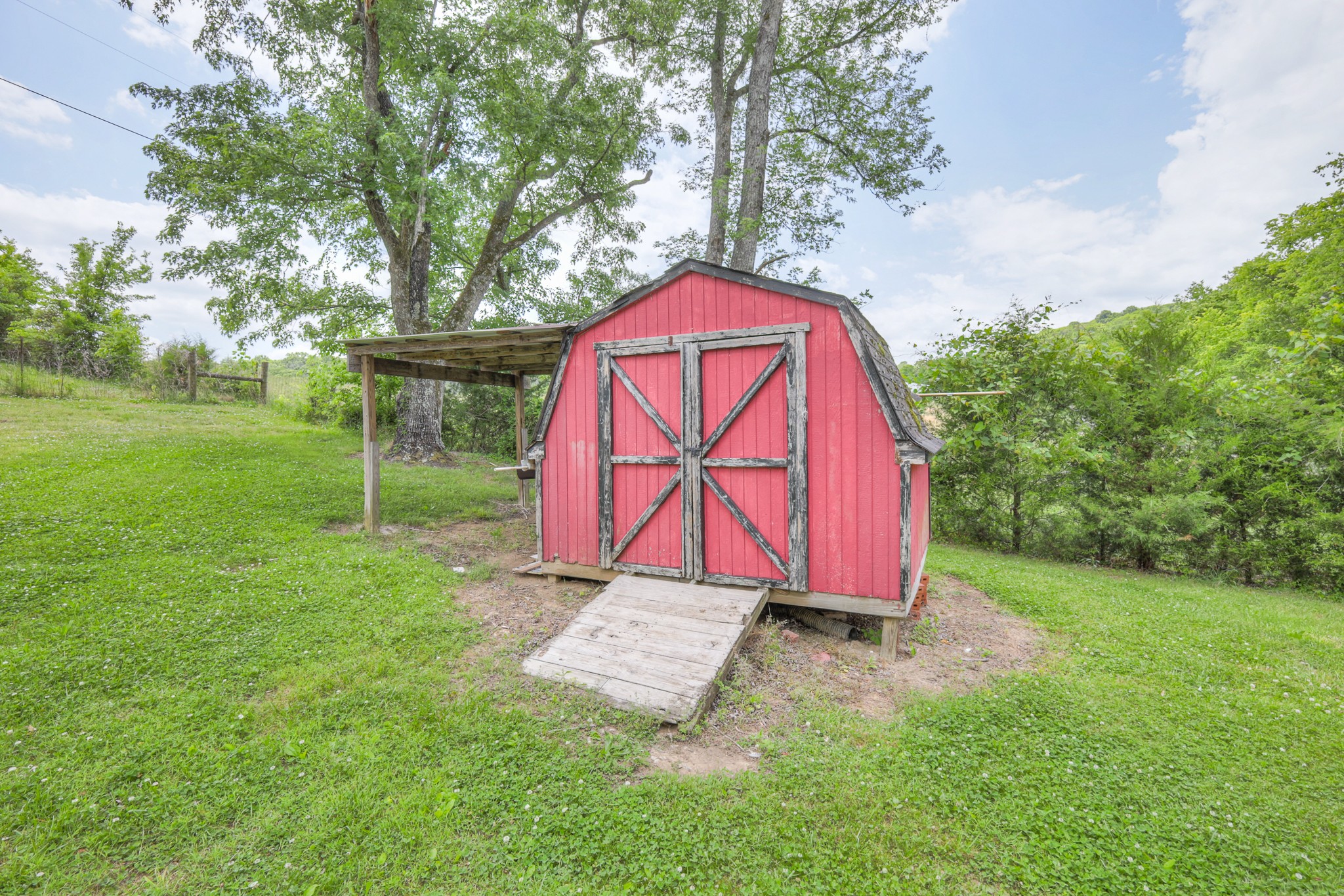 11914 Hogwood Road Milton, TN 37118 - Photo 31 of 44 a view of backyard with green space and trampoline