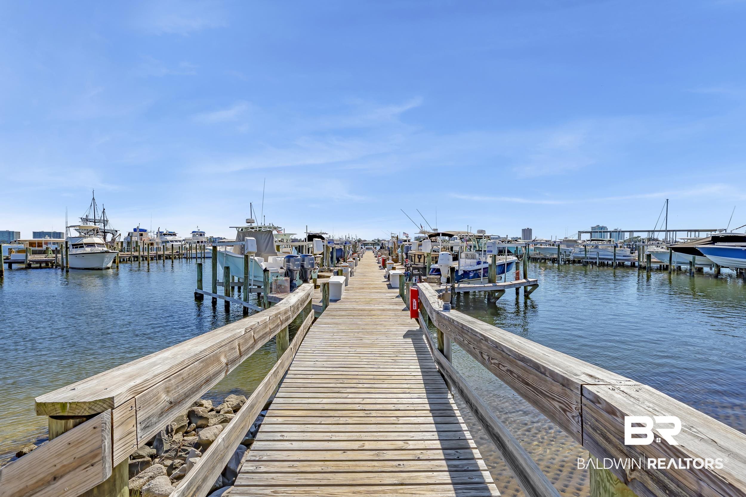 27282 Canal Road, Unit 104 Orange Beach, AL 36561 - Photo 53 of 79 Dock area with boat lift and a water view