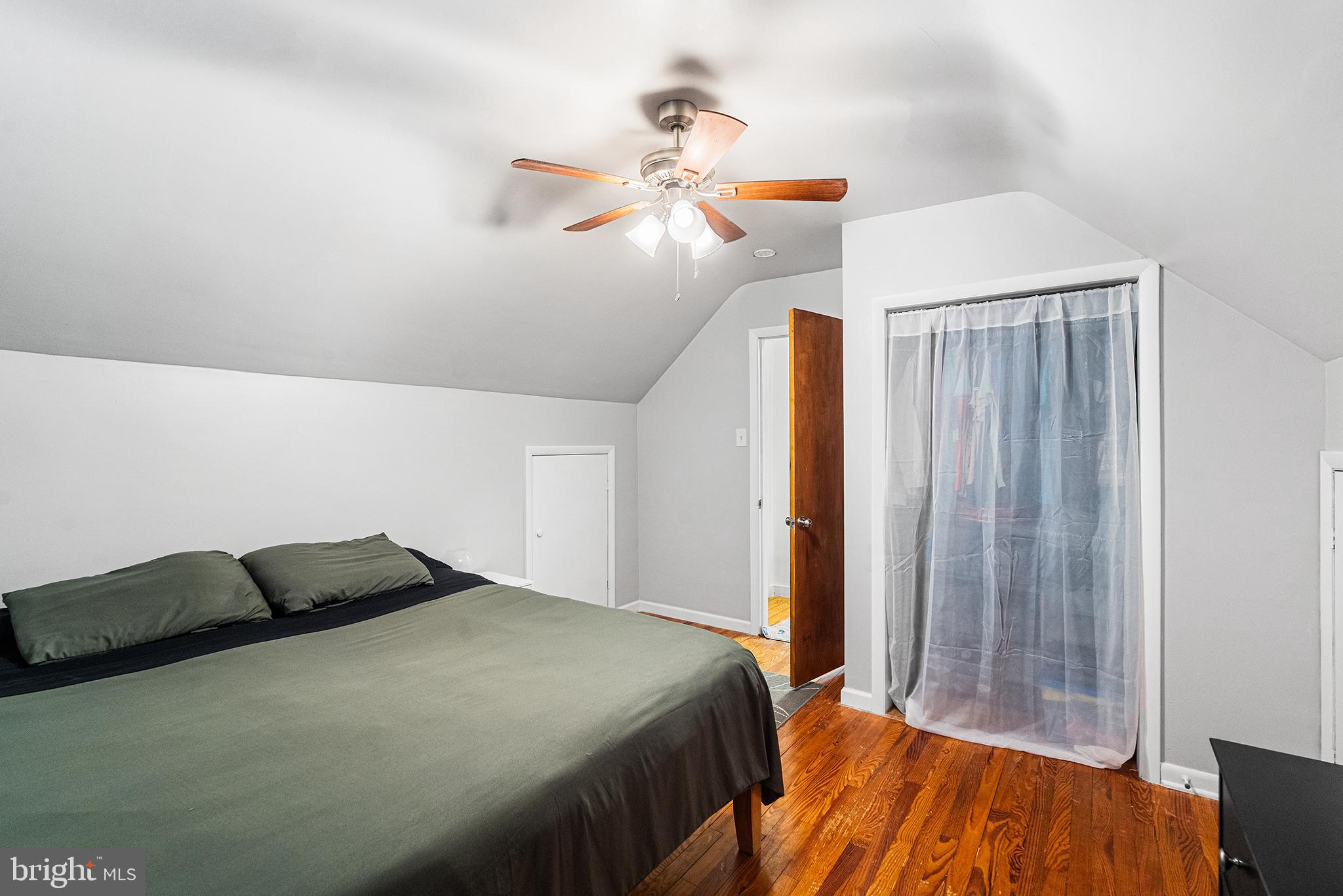 225 McClellan Street Reading, PA 19611 - Photo 16 of 25 a bedroom with a bed and a chandelier