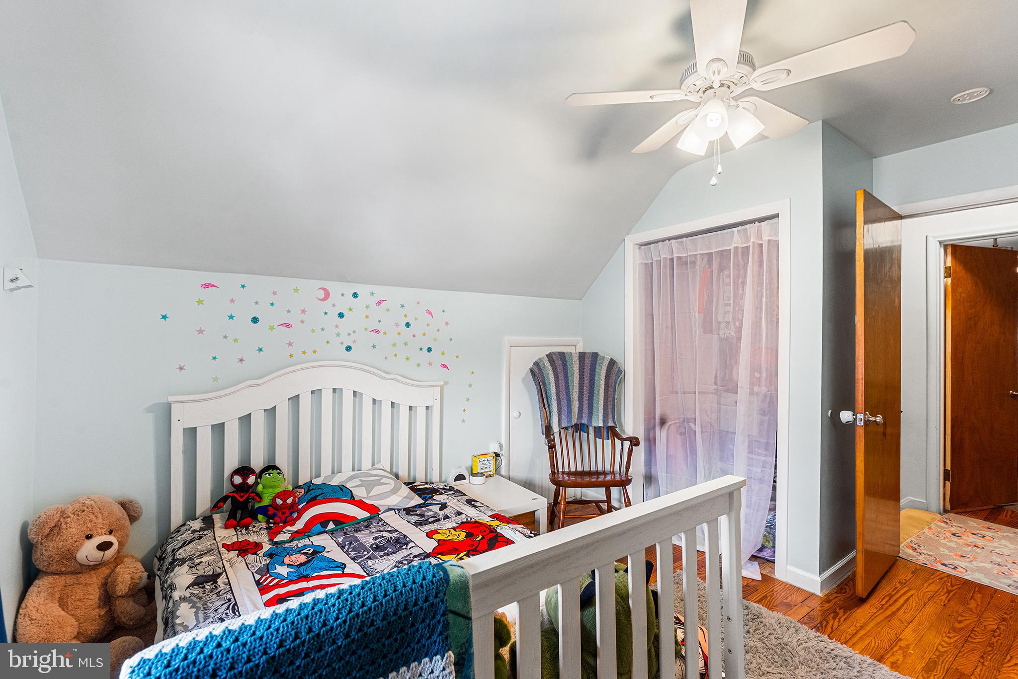 225 McClellan Street Reading, PA 19611 - Photo 18 of 25 a bedroom with furniture a baby crib and a chandelier