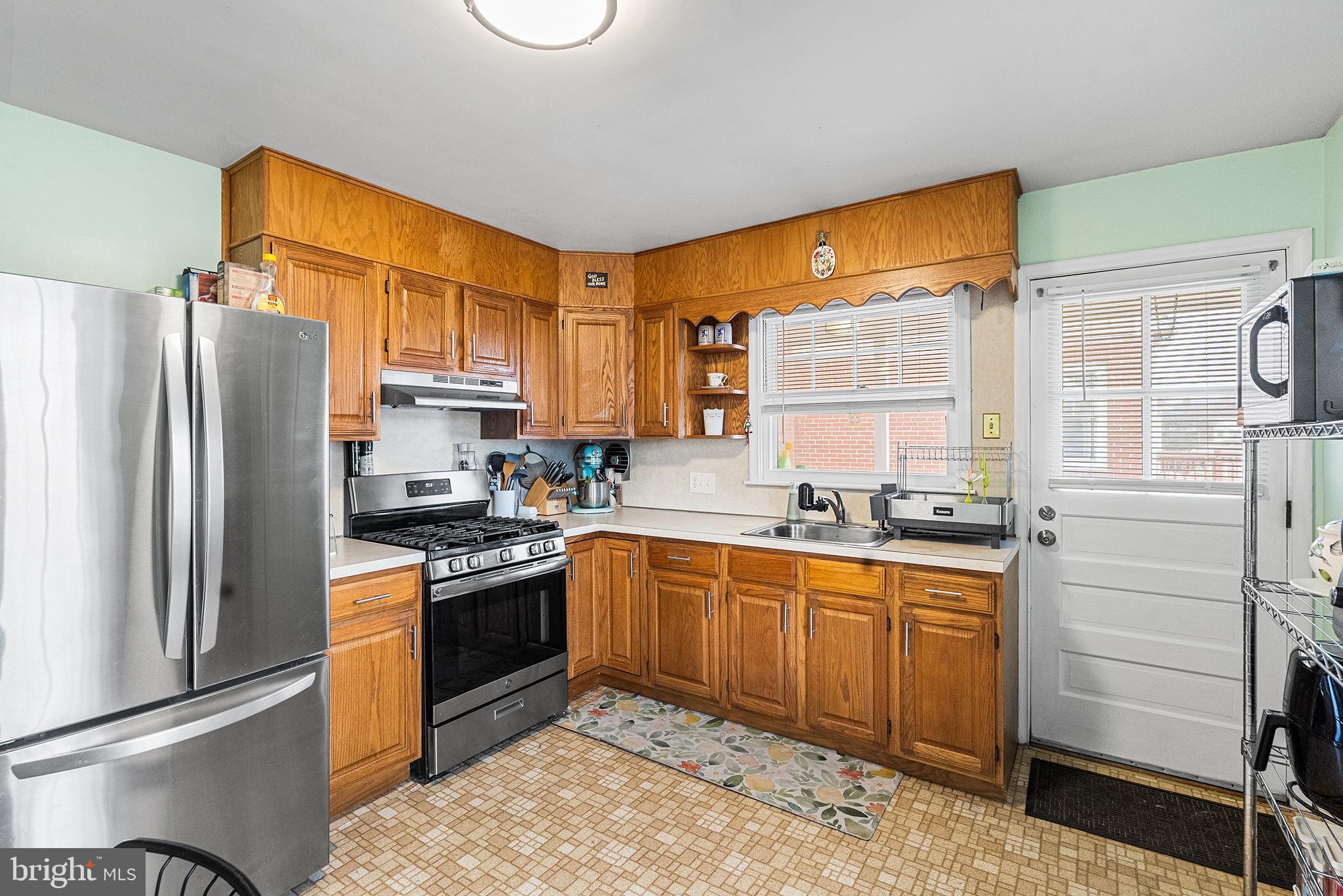 225 McClellan Street Reading, PA 19611 - Photo 7 of 25 a kitchen with stainless steel appliances granite countertop a sink stove and refrigerator