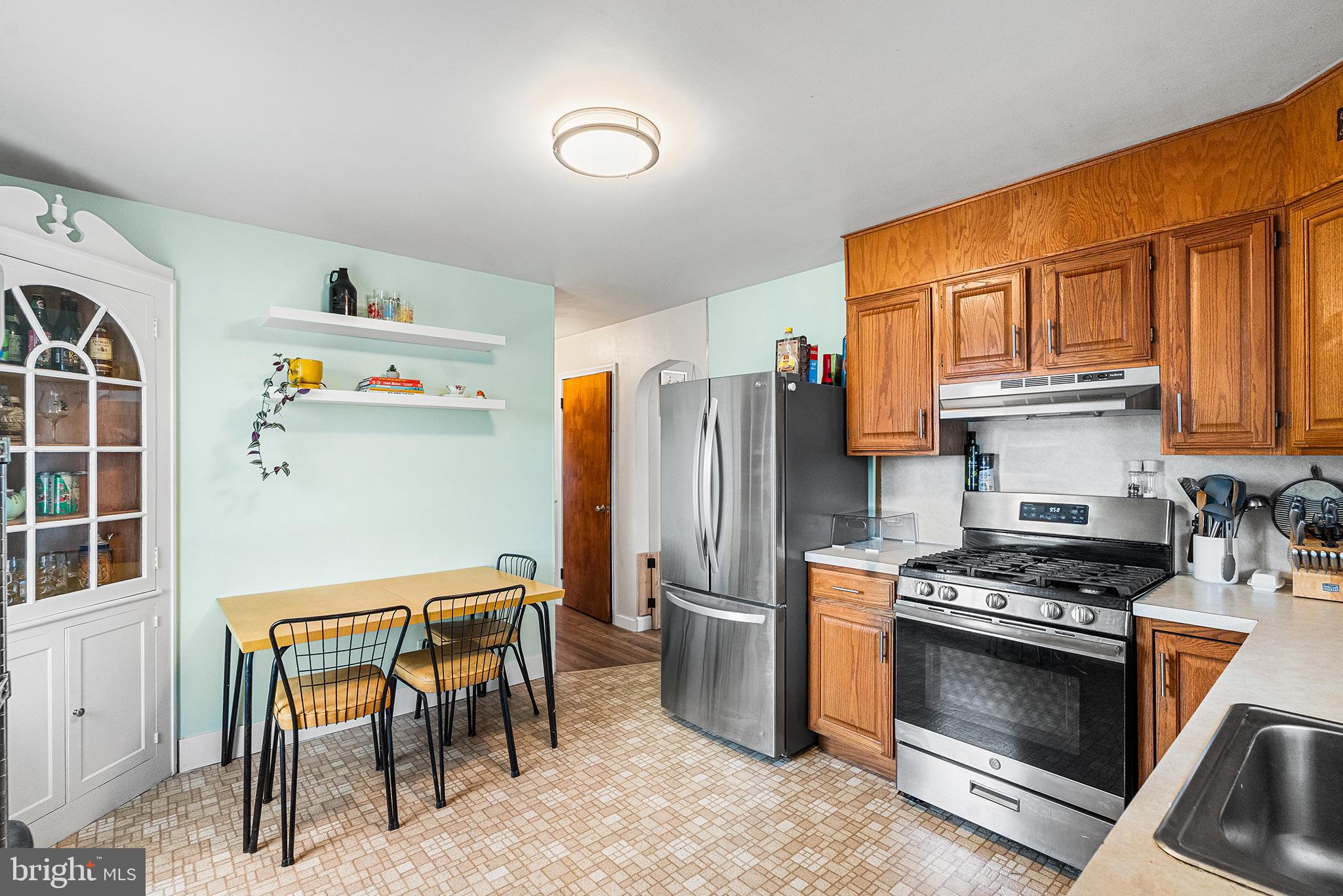 225 McClellan Street Reading, PA 19611 - Photo 8 of 25 a kitchen with stainless steel appliances granite countertop a stove a refrigerator and a refrigerator