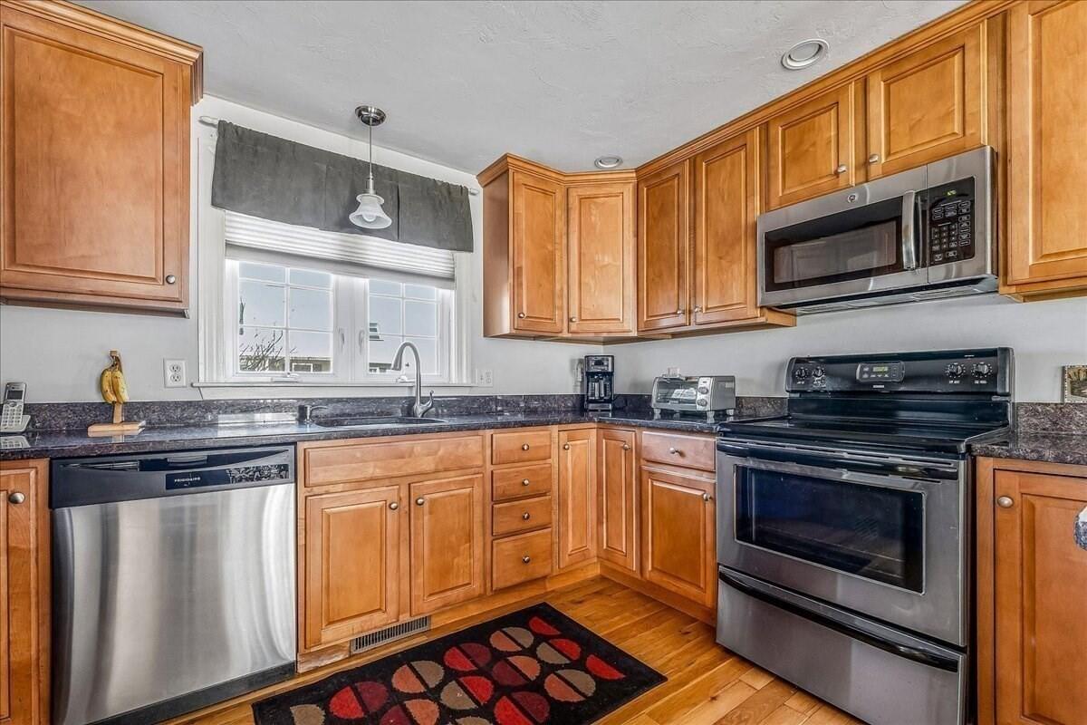 4 Old Field Road Plymouth, MA 02360 - Photo 11 of 42 a kitchen with stainless steel appliances granite countertop a stove microwave and sink