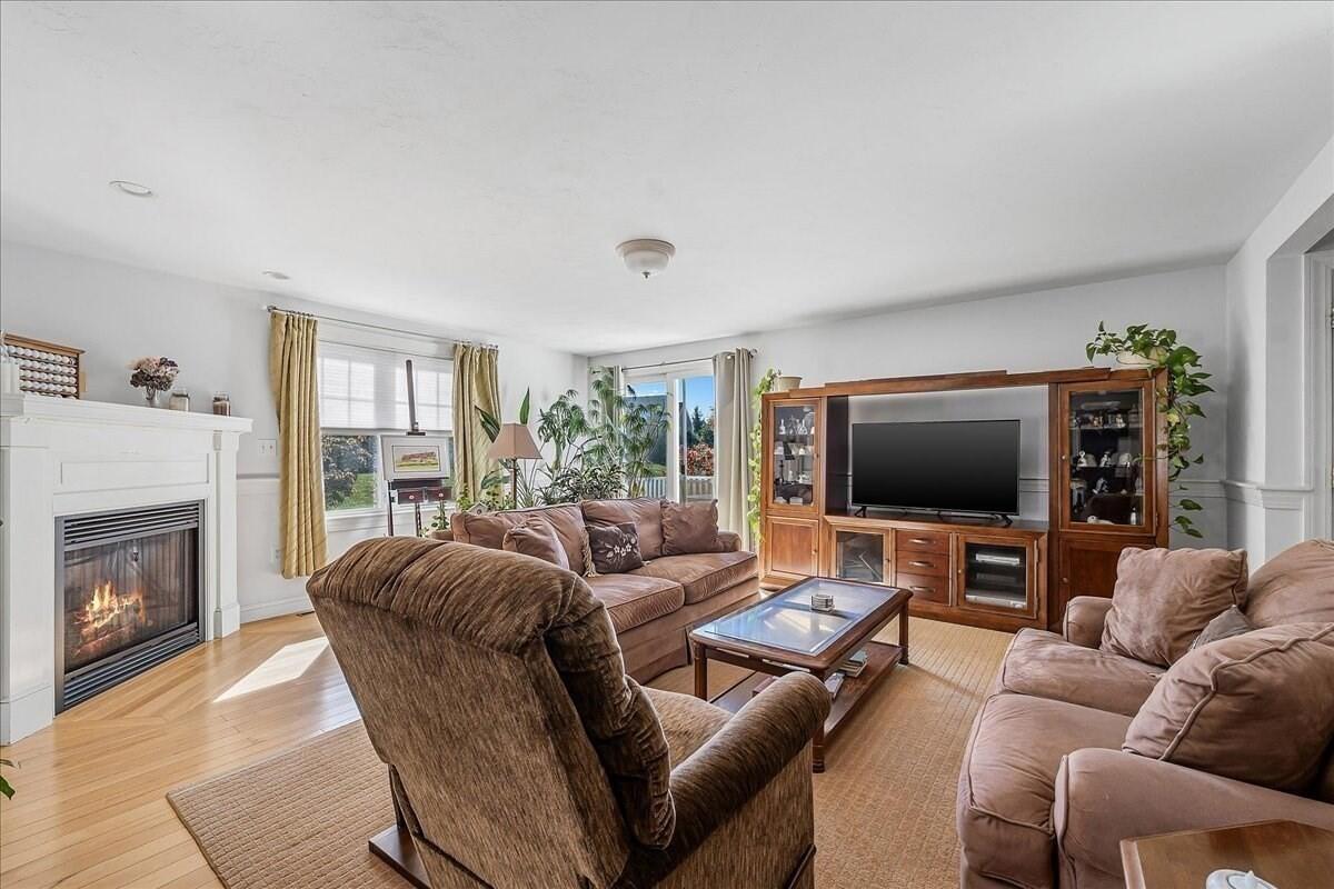 4 Old Field Road Plymouth, MA 02360 - Photo 18 of 42 a living room with furniture a flat screen tv and a fireplace
