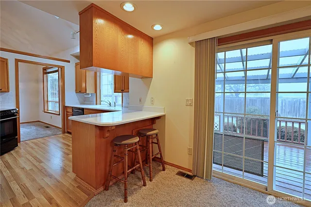 a kitchen with a sink and a large window