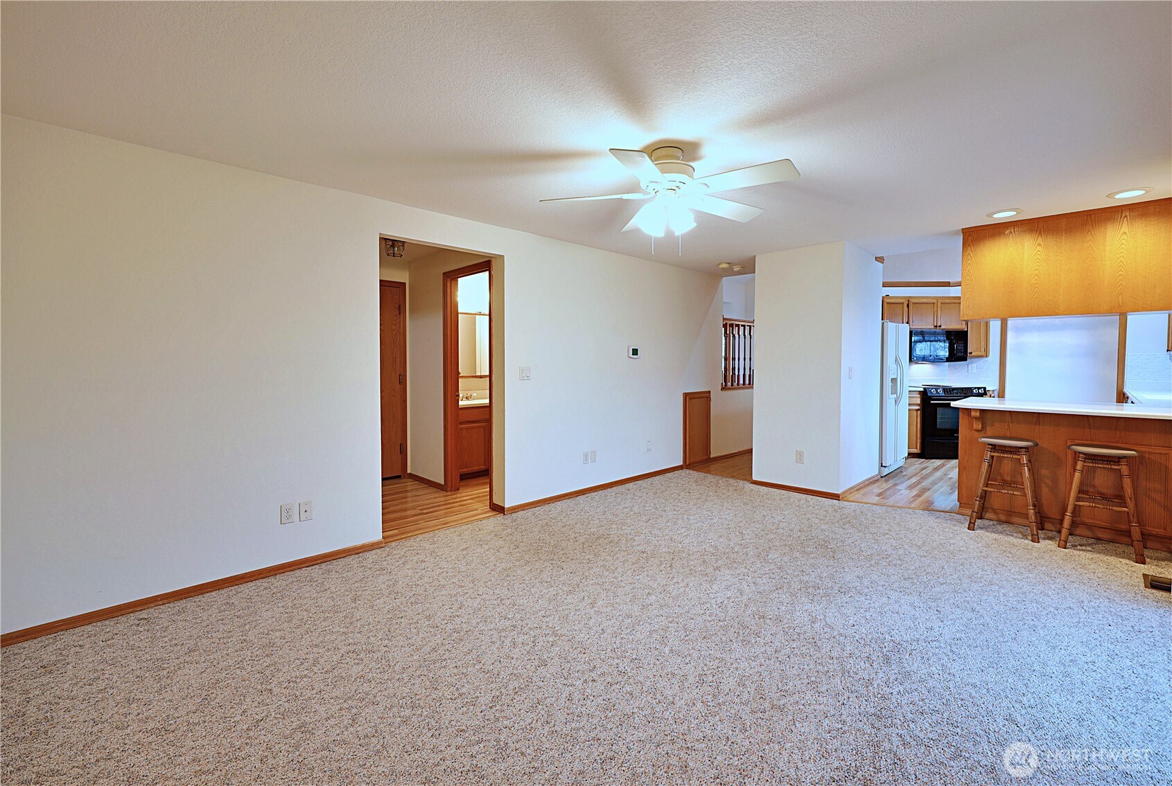 424 16th Street Southwest Puyallup, WA 98371 - Photo 14 of 39 a view of an empty room with window and a kitchen
