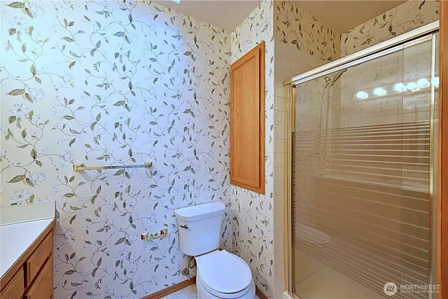 a bathroom with a toilet and a shower curtain