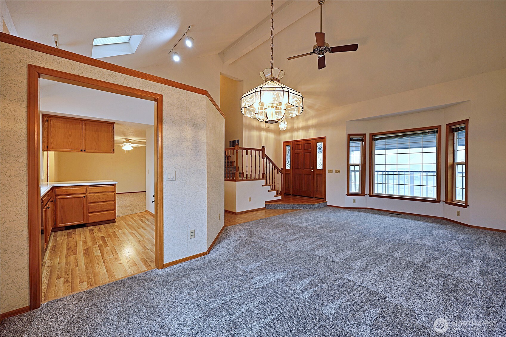 424 16th Street Southwest Puyallup, WA 98371 - Photo 7 of 39 an empty room with chandelier fan and windows