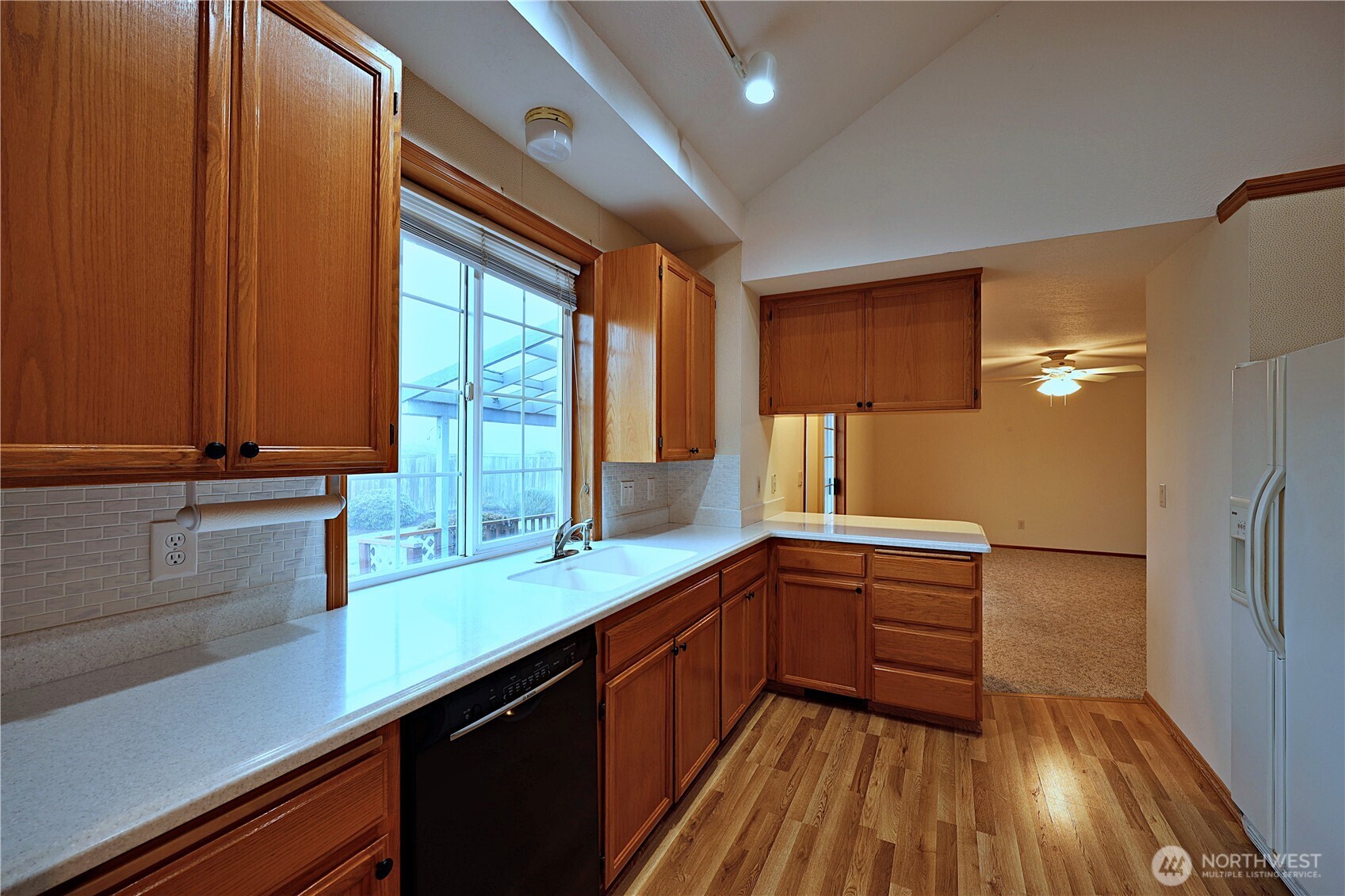 424 16th Street Southwest Puyallup, WA 98371 - Photo 8 of 39 a kitchen with wooden floors and sink