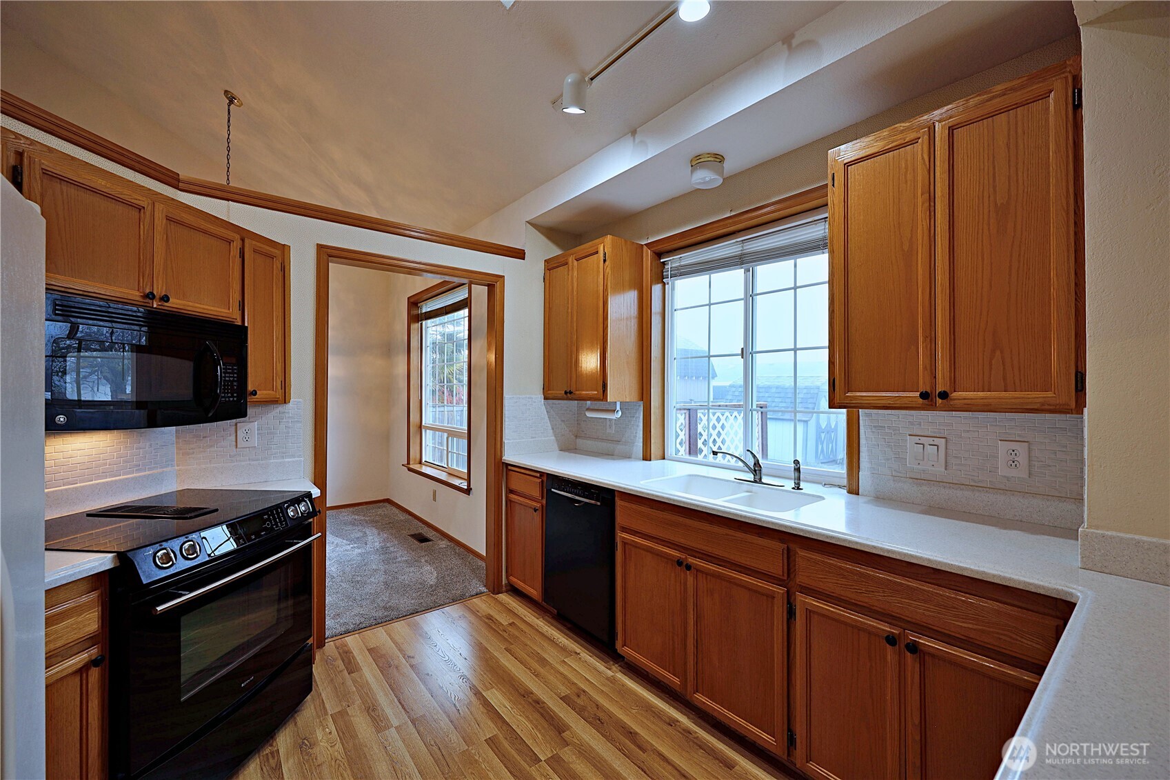 424 16th Street Southwest Puyallup, WA 98371 - Photo 9 of 39 a kitchen with stainless steel appliances granite countertop a sink stove and refrigerator