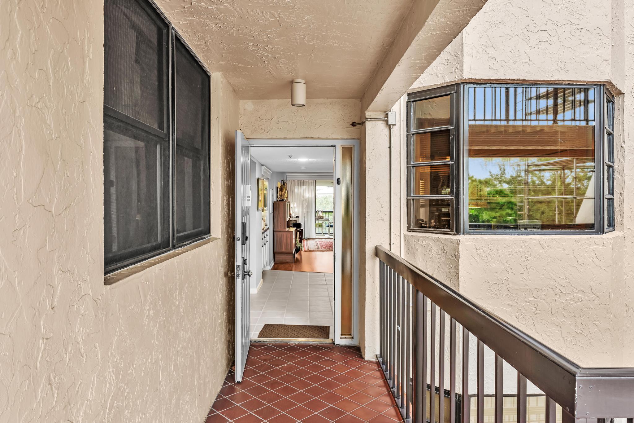 6320 Boca Del Mar Drive, Unit 303 Boca Raton, FL 33433 - Photo 2 of 42 a view of a balcony from a hallway