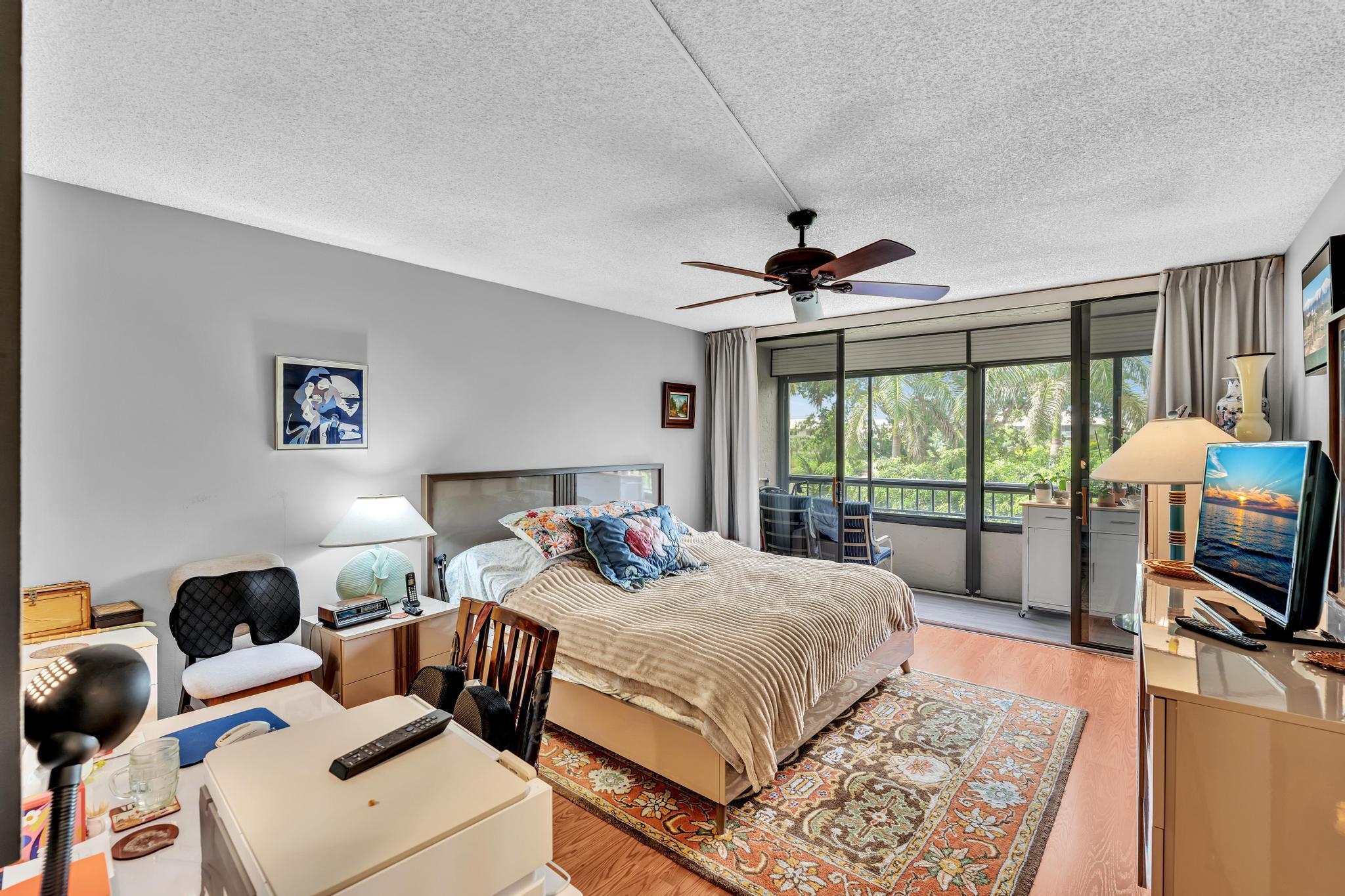 6320 Boca Del Mar Drive, Unit 303 Boca Raton, FL 33433 - Photo 24 of 42 a bed room with a bed and a television