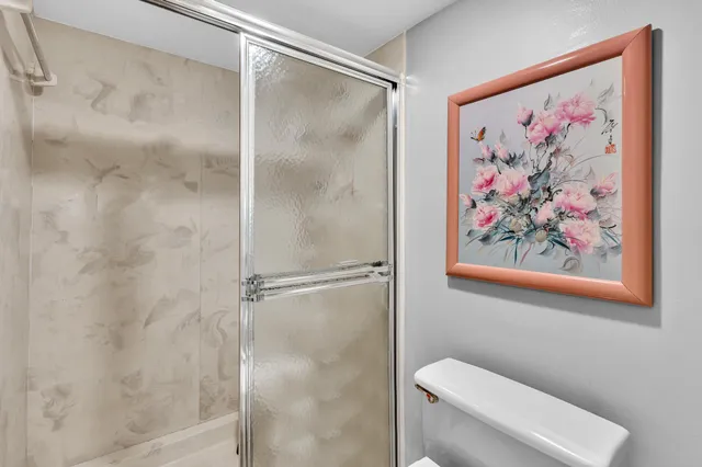 a bathroom with a toilet and a shower