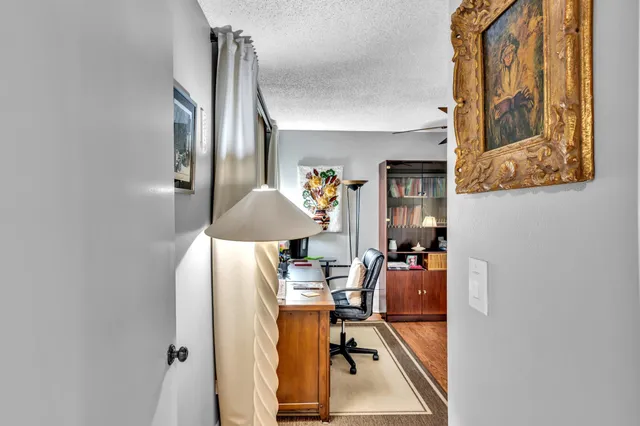 a view of living room with furniture and a lamp