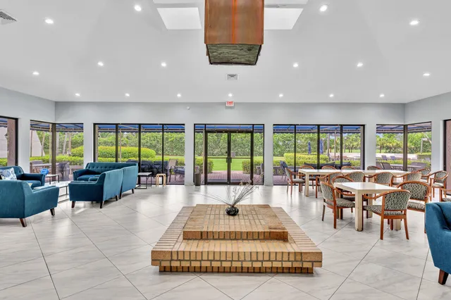 a view of a patio with table and chairs potted plants with wooden floor and fence