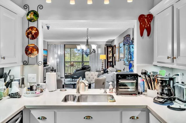 a kitchen with a refrigerator and a sink