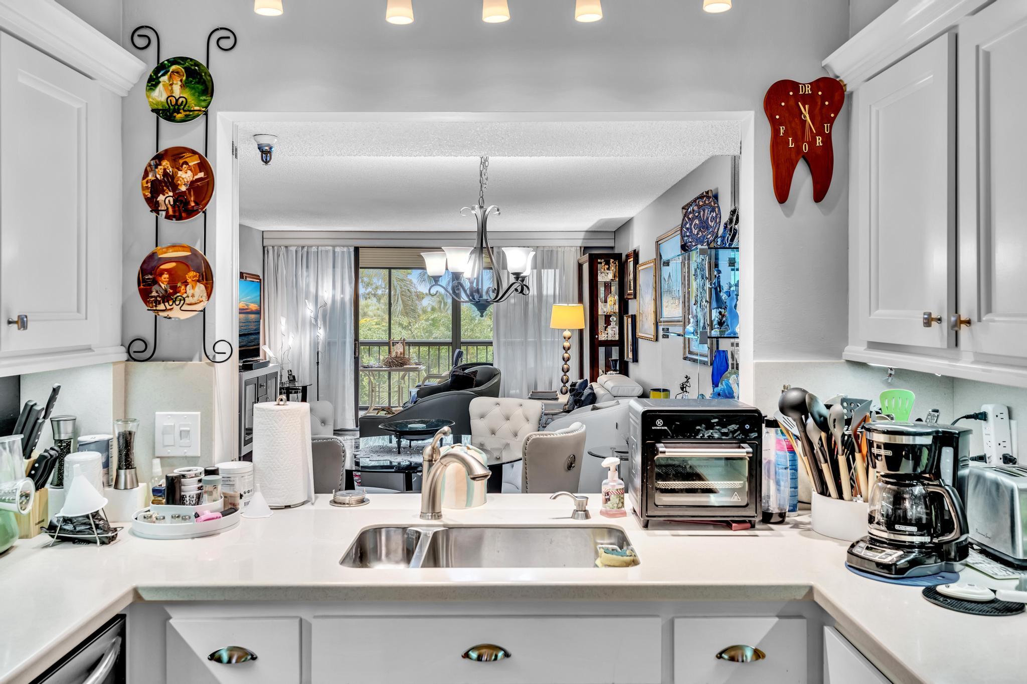6320 Boca Del Mar Drive, Unit 303 Boca Raton, FL 33433 - Photo 8 of 42 a kitchen with a refrigerator and a sink