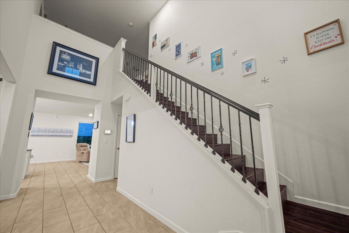 12791 Evanston Way Rancho Cordova, CA 95742 - Photo 15 of 54 a view of a hallway with wooden floor and stairs