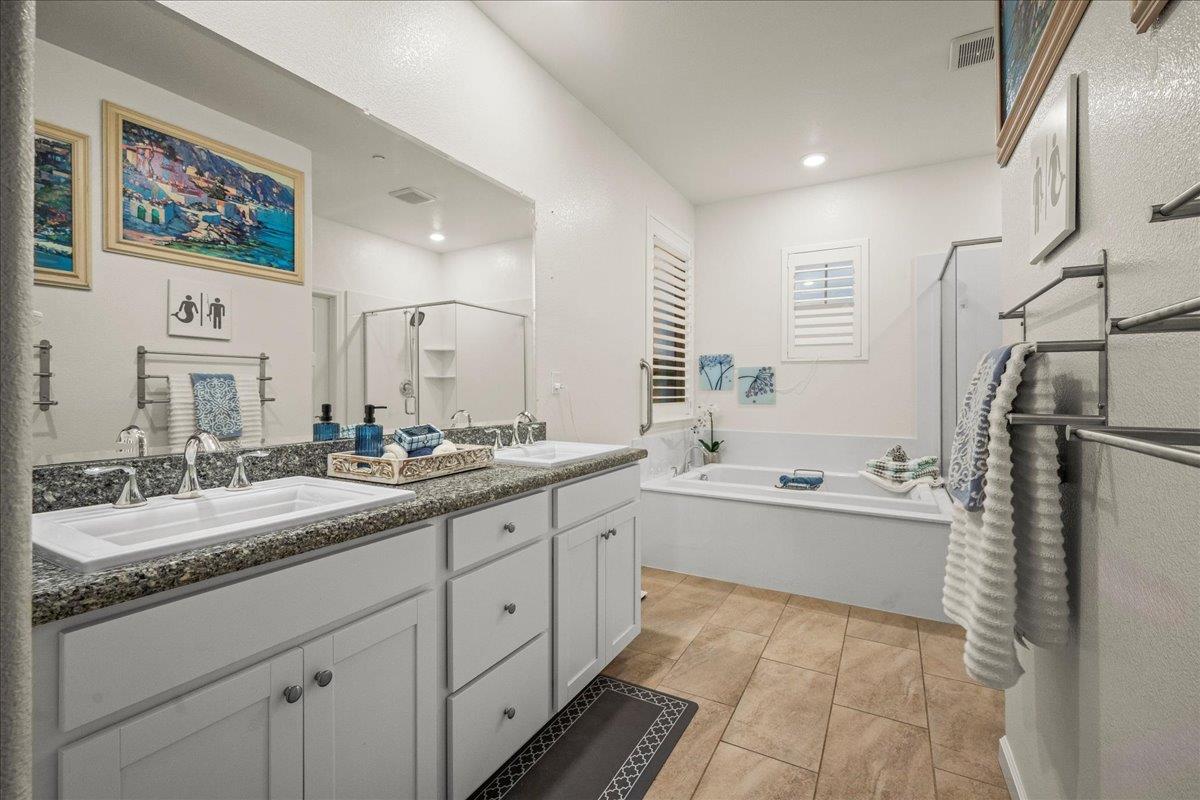 12791 Evanston Way Rancho Cordova, CA 95742 - Photo 22 of 54 a bathroom with a granite countertop sink mirror and bathtub
