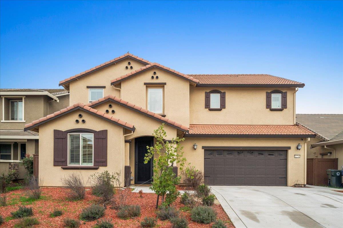 12791 Evanston Way Rancho Cordova, CA 95742 - Photo 29 of 54 a front view of a house with a yard and garage