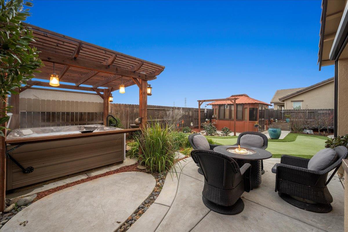 12791 Evanston Way Rancho Cordova, CA 95742 - Photo 41 of 54 a view of a patio with table and chairs under an umbrella with a small yard