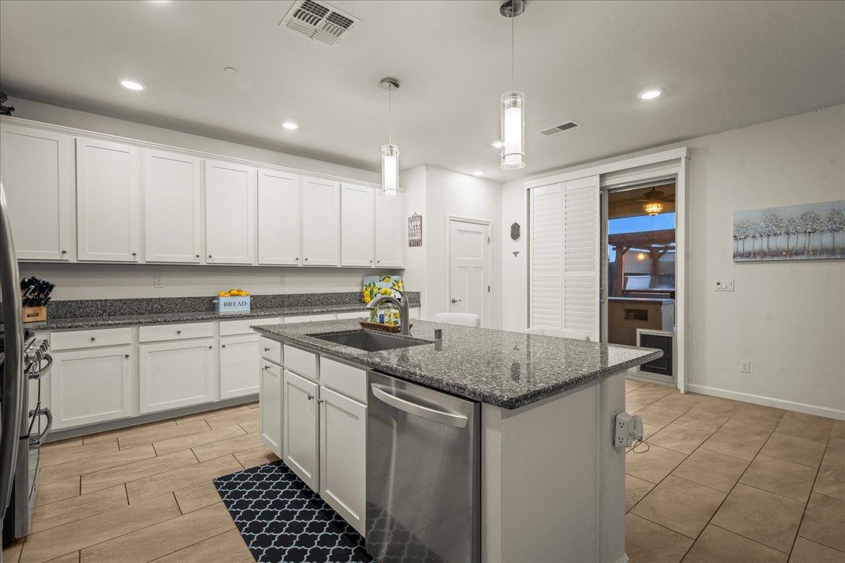 12791 Evanston Way Rancho Cordova, CA 95742 - Photo 43 of 54 a kitchen with stainless steel appliances granite countertop a sink stove and cabinets