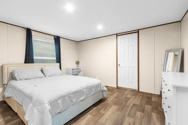 a bedroom with a large bed and a large window