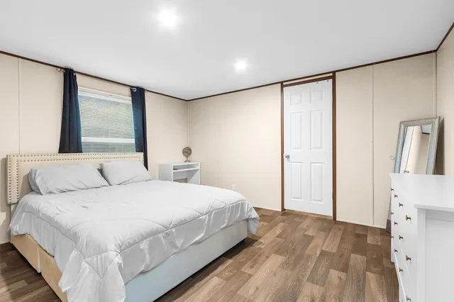 a bedroom with a large bed and a large window