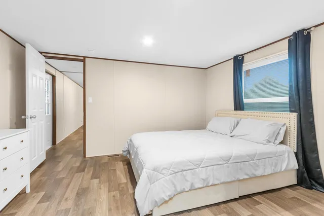 a bedroom with a large bed and a window