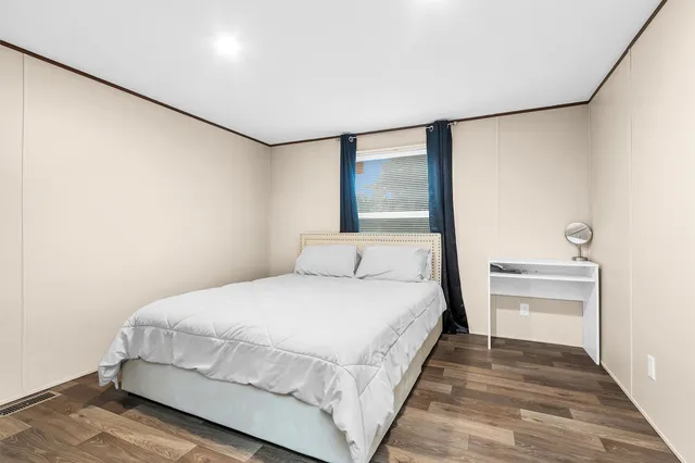 a bedroom with a bed and a night stand