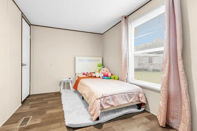 a bedroom with a bed and a window with the outer view